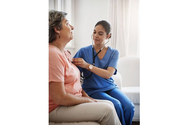 everything sounds good attractive young female nurse examining senior patient everything sounds good attractive young female nurse examining senior patient