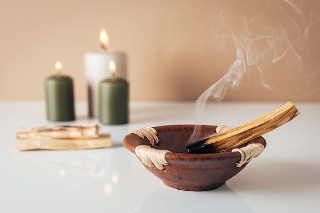 palo santo burning stick candles background copyspace