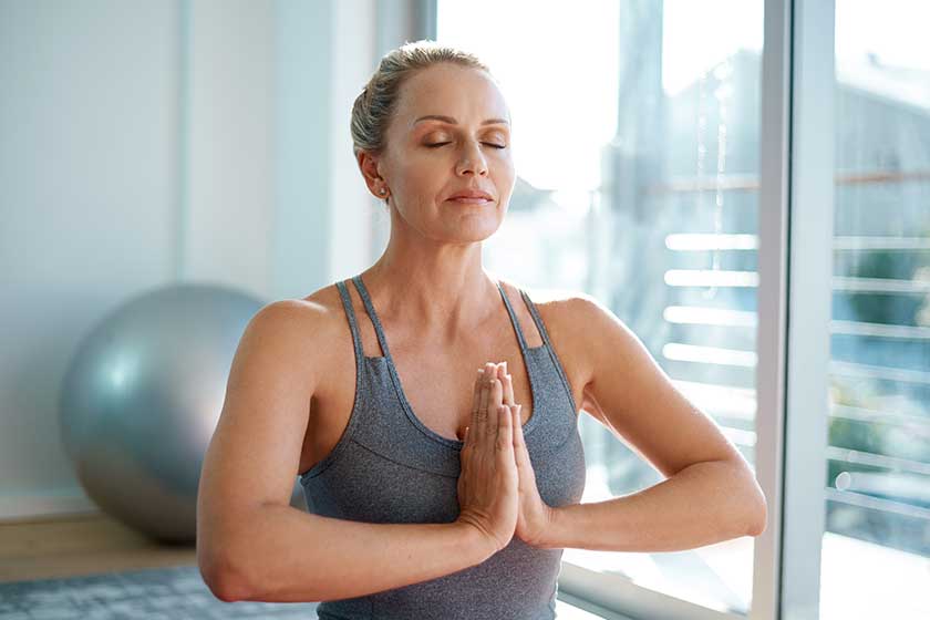 perfect balance attractive mature woman meditating home