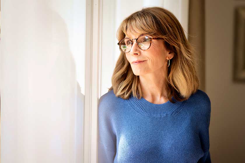 portrait beautiful middle aged woman smiling window blond haired female