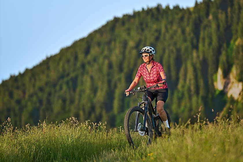 portrait pretty senior woman riding her electric mountain bike mountains