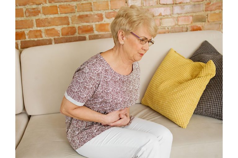 senior woman having stomachache