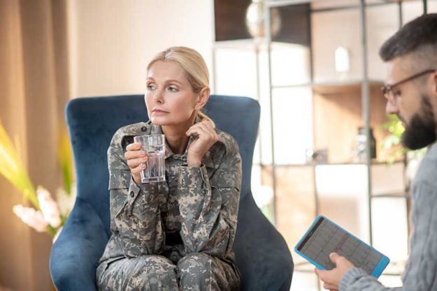 Servicewoman scheduling next appointment with young psychologist
