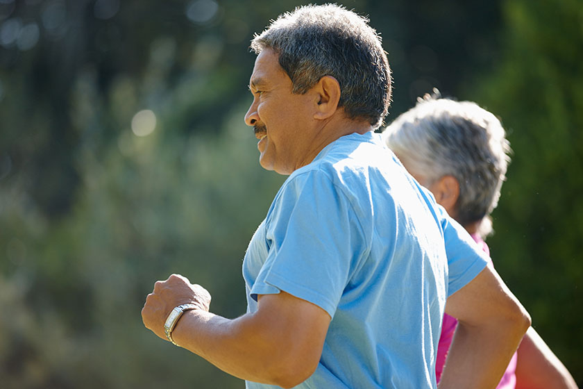 staying active mature couple jogging together sunny day