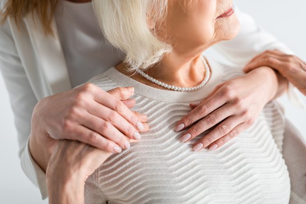 cropped view daughter hugging senior mother grey hair cropped view daughter hugging senior mother grey hair