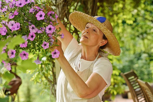 senior woman with hanging pot senior woman with hanging pot