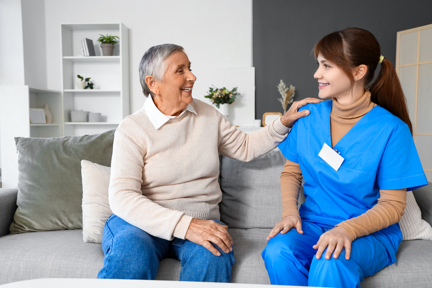 Senior woman with caregiver at home