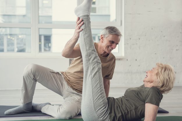 Glad old couple working out at fitness studio Glad old couple working out at fitness studio