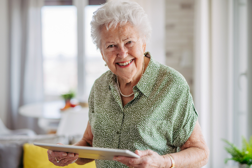Portrait of beautiful senior lady with tablet in hands at home. Portrait of beautiful senior lady with tablet in hands at home.