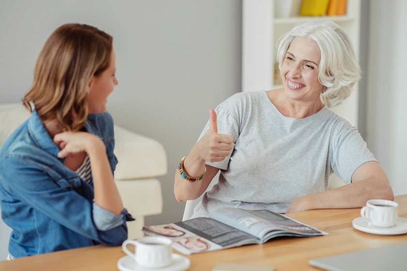 Cheerful aged woman resting with her daughter Cheerful aged woman resting with her daughter