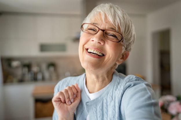 Close up portrait of one senior woman with short hair happy smil Close up portrait of one senior woman with short hair happy smil