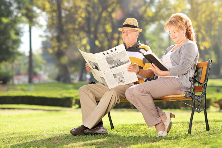 Mature couple relaxing on a bench in park