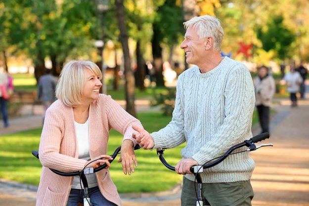 cute elderly couple with bicycles in autumn park cute elderly couple with bicycles in autumn park