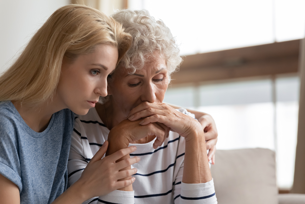 Empathic daughter embracing desperate middle aged mother Empathic daughter embracing desperate middle aged mother