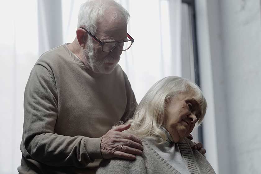 Senior man eyeglasses calming upset wife dementia