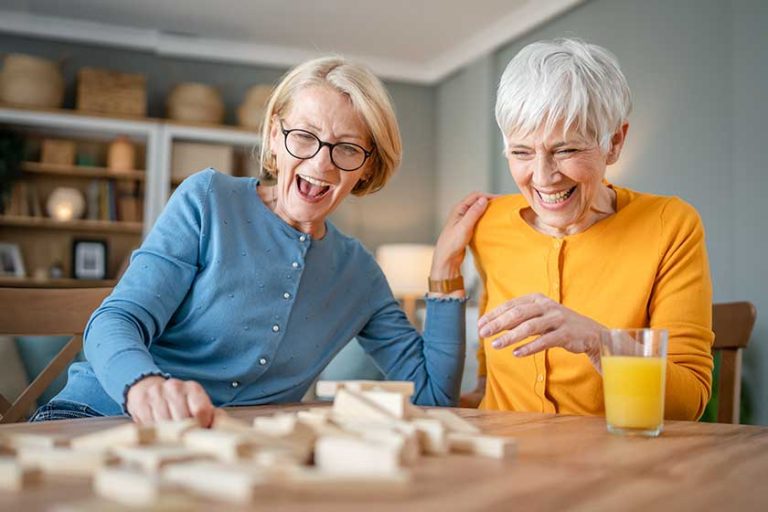 Two senior women female woman friends family sisters play leisure