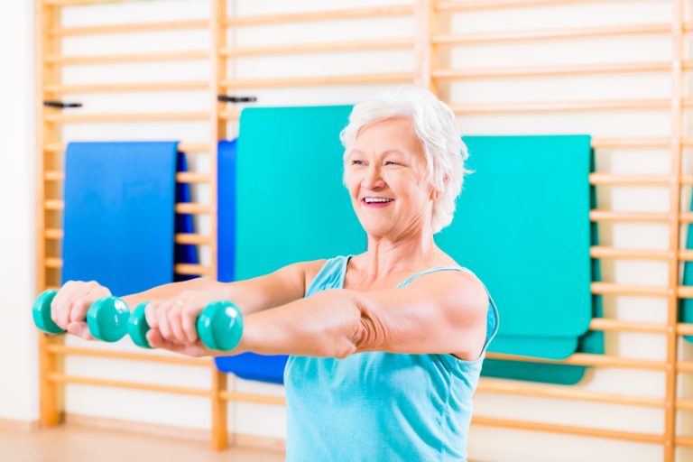 Senior woman doing fitness sport in gym