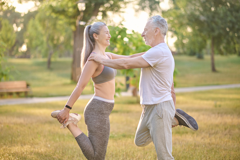 Two sportive mature adults exercising in the park Two sportive mature adults exercising in the park