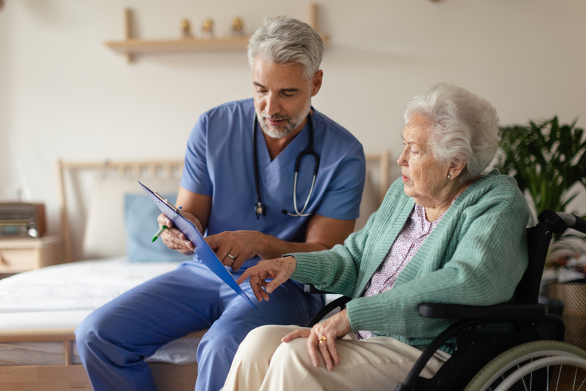 Caregiver doing regular check up of senior woman in her home. Caregiver doing regular check up of senior woman in her home.