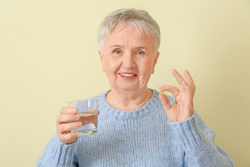 Senior woman with fish oil on color background Senior woman with fish oil on color background