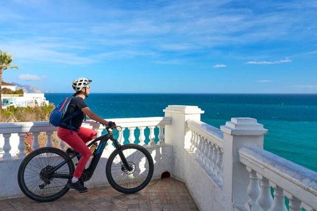 Nice senior woman cycling her electric mountain bike costa blanca