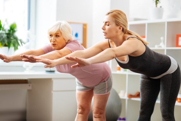 Nice fit woman training with a patient