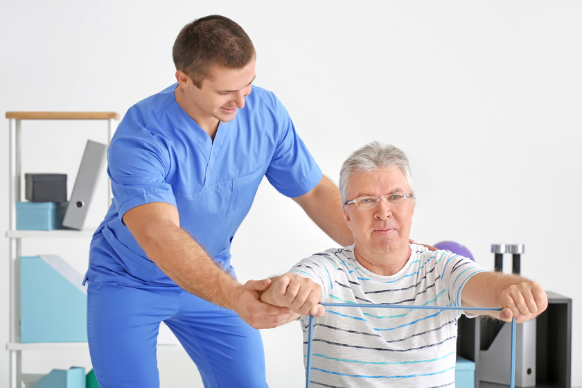 Physiotherapist working with senior patient in modern clinic Physiotherapist working with senior patient in modern clinic