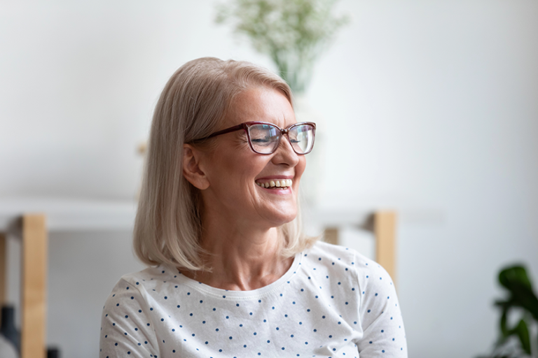 Close up happy beautiful mature woman laughing at funny joke