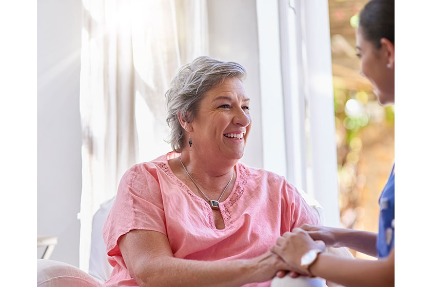 Caregiver holding hands woman support nursing home patient health sympathy