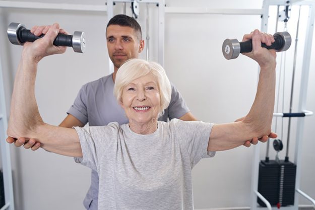 cheerful aged woman raising hand weighs over herself cheerful aged woman raising hand weighs over herself