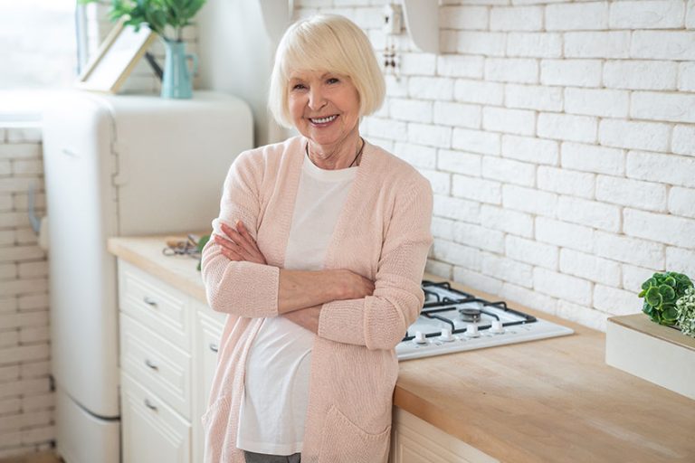 Cooking with love attractive old woman cooking on kitchen cheerful grandmother is baking
