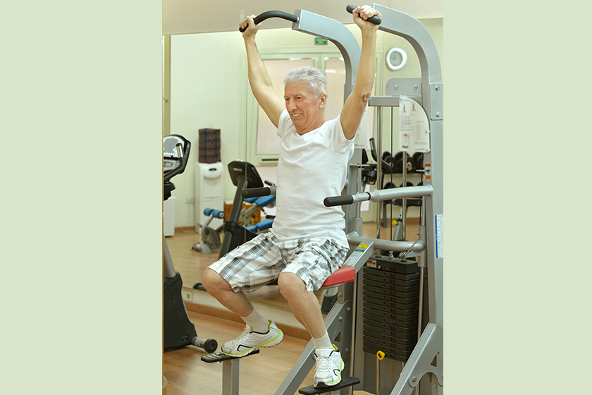elderly man playing sports in a gym elderly man playing sports in a gym