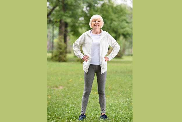 elderly sportswoman standing green lawn