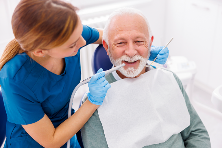 female dentist fixing patient tooth dental clinic