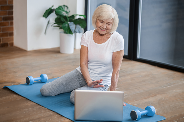 gray haired senior woman sitting on the floor