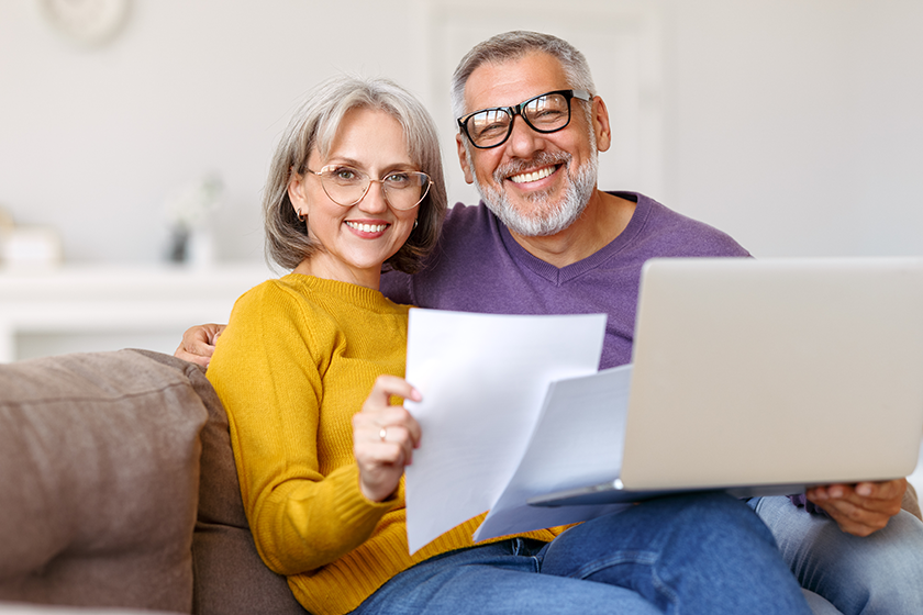 happy senior couple reading good news