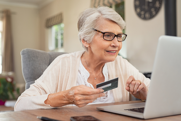 happy senior woman making online payments