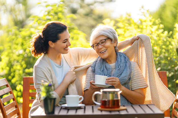 happy young woman her mother drinking tea