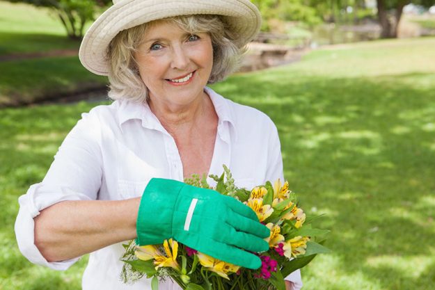Mature woman holding plant