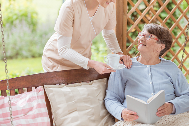 nurse giving tea happy elderly woman nurse giving tea happy elderly woman