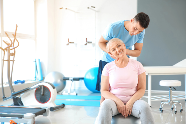 physiotherapist working with mature patient physiotherapist working with mature patient