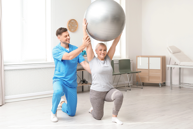 physiotherapist working with patient in clinic