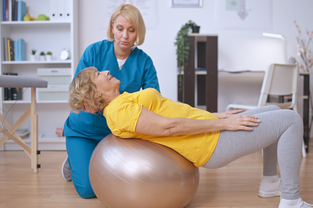 rehabilitation doctor helps patient train her back