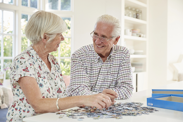 senior couple doing jigsaw puzzle