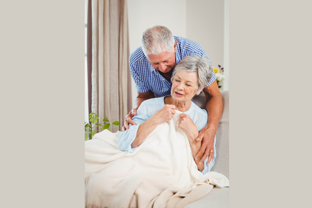 senior man embracing woman