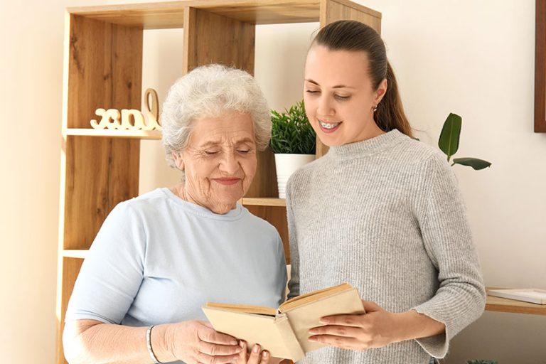 Senior woman her granddaughter reading book home