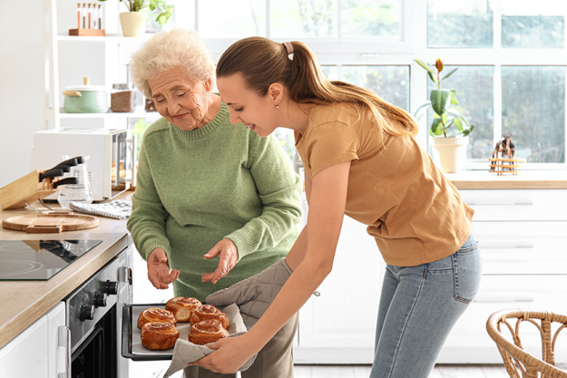senior woman her granddaughter taking buns