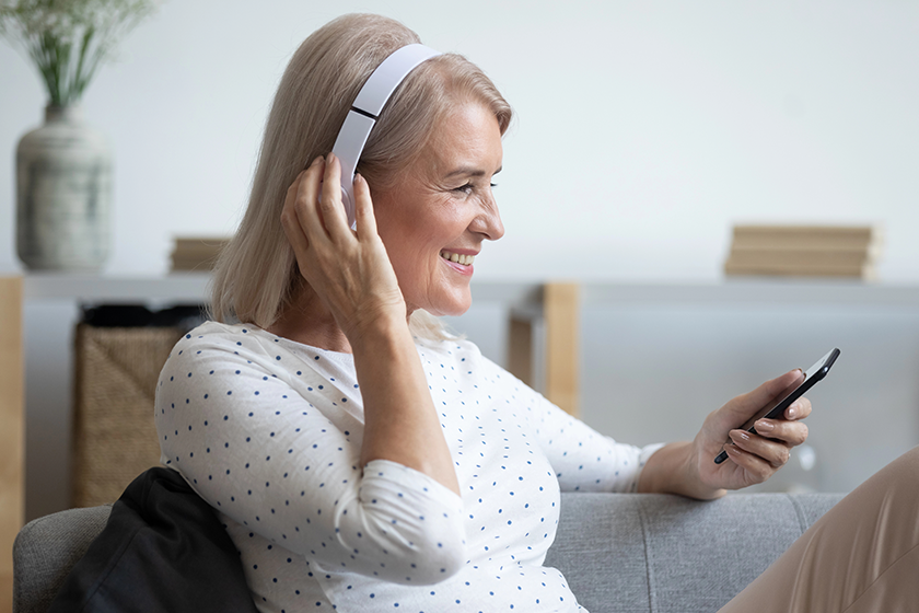smiling mature woman in headphones