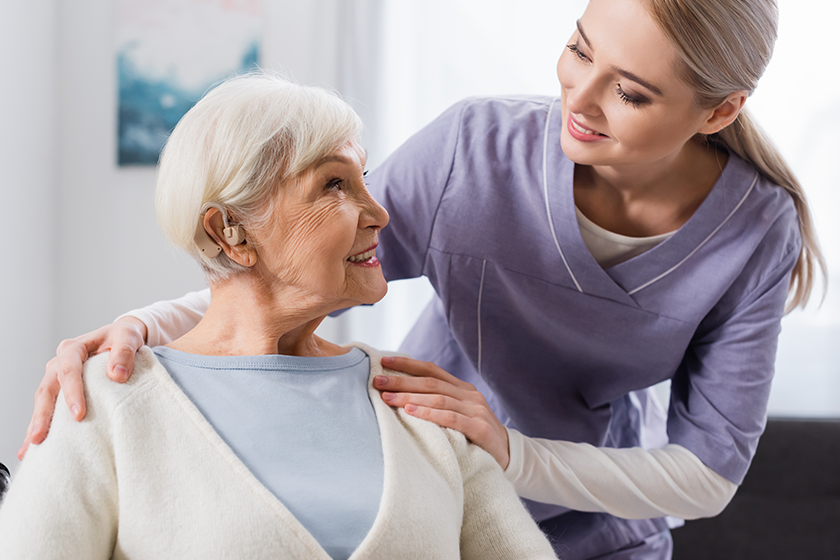 smiling social worker hugging shoulder smiling social worker hugging shoulder