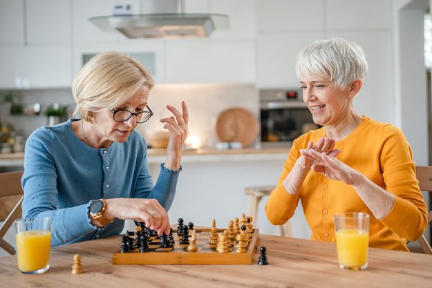 Two senior mature women caucasian female woman friends sisters play